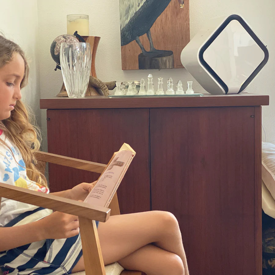 avari av-qb air purifier near a girl reading a book