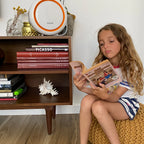 avari av-500 orange air purifier near a girl reading a book
