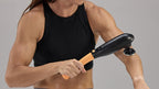 woman using purewave cmx massager on her elbow